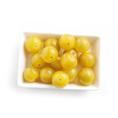 Dish full of ripe fresh yellow cherry tomatoes