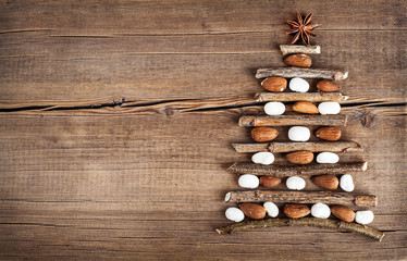 Christmas card with natural decorations on wooden background