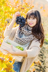  happy young woman with grape in hand