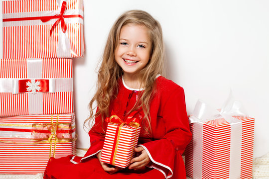 Happy girl with red gift boxes