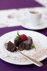 Chocolate fondant on a white plate and coffee