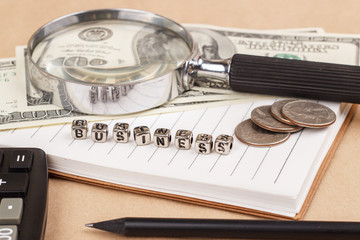 Word business. Dollars, coins and notes.