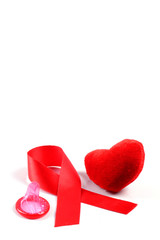 Aids ribbon, heart and condom on white background.
