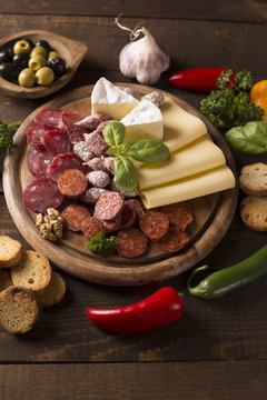 appetizer with sausages,cheese,olive and nuts