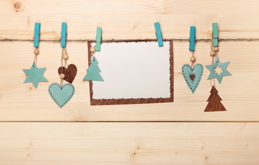 Christmas card: decoration and paper sheet on wooden background
