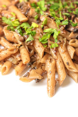 Pasta with wild mushrooms and parsley on a white background. Selective Focus.