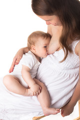 Mom feeds the baby breast, light background