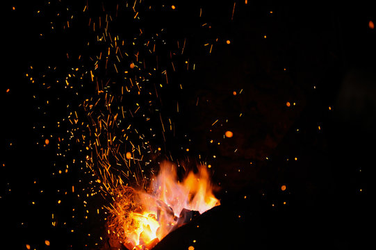 The flame sparks from a forge