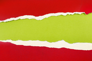 Ripped red paper on green background