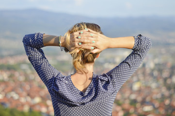 Girl facing the cityview from mountain viewpoint
