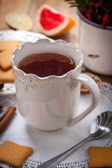 Winter hot drink with spices on wooden table.