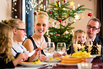 Family having Christmas dinner sausages