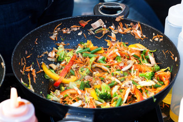 stir fried vegetables in the pan and pasta