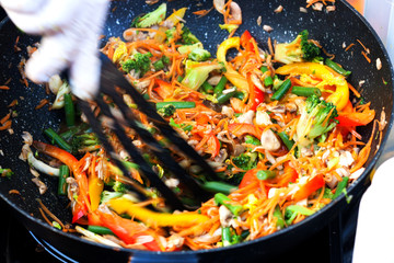 stir fried vegetables in the pan and pasta