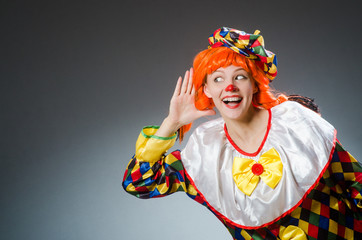 Clown in funny concept on dark background