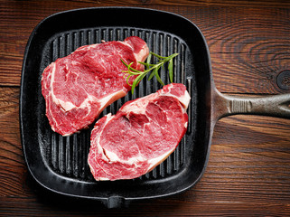 fresh raw beef steak on cooking pan