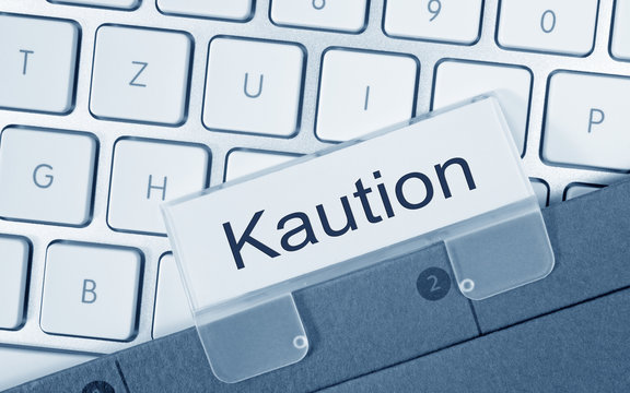 Kaution - Ordner auf Computer Tastatur im B&uuml;ro