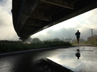 Silhouette of man running on path