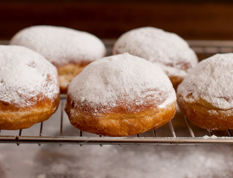 donut with powder sugar against dark background