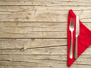 Cutlery kitchenware on old wooden boards background