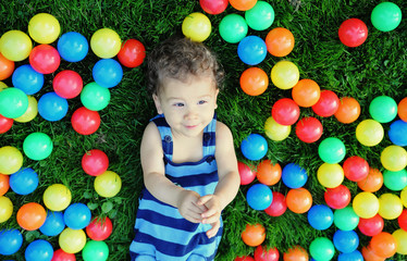 Fototapeta na wymiar Cute boy playing with balloons outdoor