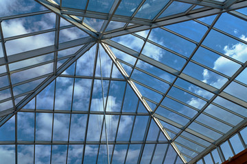 View of the clouds in the sky through the glass roof.