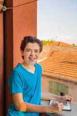 Fototapeta premium Latin boy with braces holding tablet