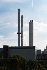 Fototapeta na wymiar Generating plant tiefstack with smokestacks against blue sky in Hamburg. Powerhouse in industrial technology area in Germany 