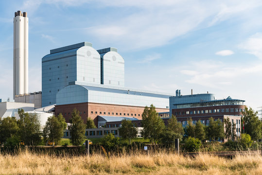 Generating plant tiefstack with smokestacks against blue sky in Hamburg. Powerhouse in industrial technology area in Germany 