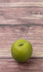 Pickled green olives over wooden background