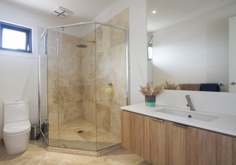 Corner shower marble tiling in contemporary bathroom