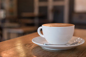 Hot art Latte Coffee in a cup on wooden table