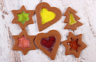 Stained glass gingerbread on old wooden background, christmas time