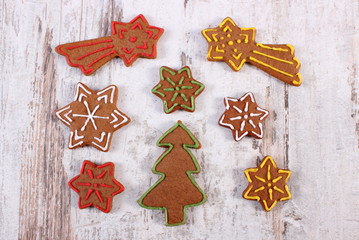 Fototapeta na wymiar Fresh baked decorated gingerbread on old wooden background, christmas time