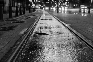 Night view on wet tram rails after rain