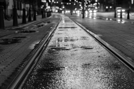 Night view on wet tram rails after rain