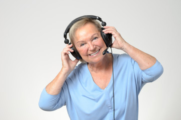 Excited senior woman listening to music