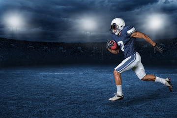 American Football Player Running for a touchdown in a large outdoor professional football stadium at night - Powered by Adobe