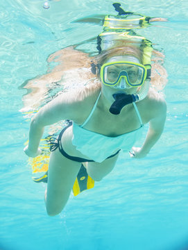 Underwater portrait of a woman snorkeling in clear tropical sea