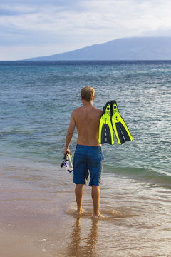 Rear view of an attractive man going snorkeling in Hawaii