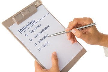 Hand fills out job interview checklist