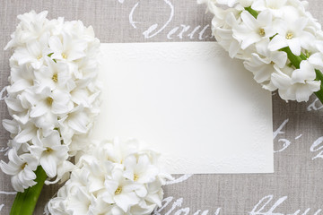 White hyacinth flowers on grey background with handwritten words