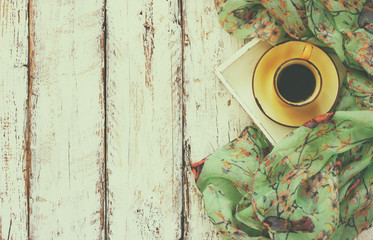 top view image of chiffon fashion scarf with to cup of coffee on a wooden table. retro filtered photo
