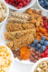 assortment of cereal muesli bars, fresh and dried fruit on plate