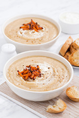 cream soup with caramelized carrots, closeup, vertical