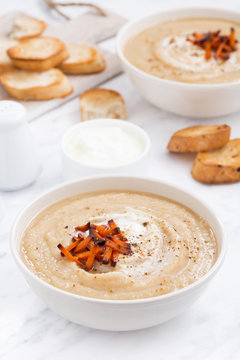 cream soup with caramelized carrots and croutons, vertical