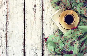 top view image of chiffon fashion scarf with to cup of coffee on a wooden table
