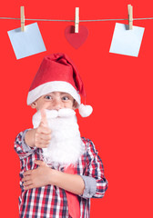 Cute little Santa Claus showing thumbs up gesture
