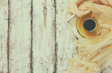 top view image of chiffon fashion scarf with to cup of coffee on a wooden table

