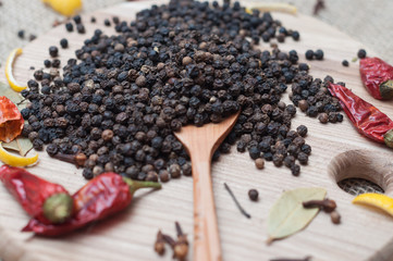 black pepper on wooden spoon